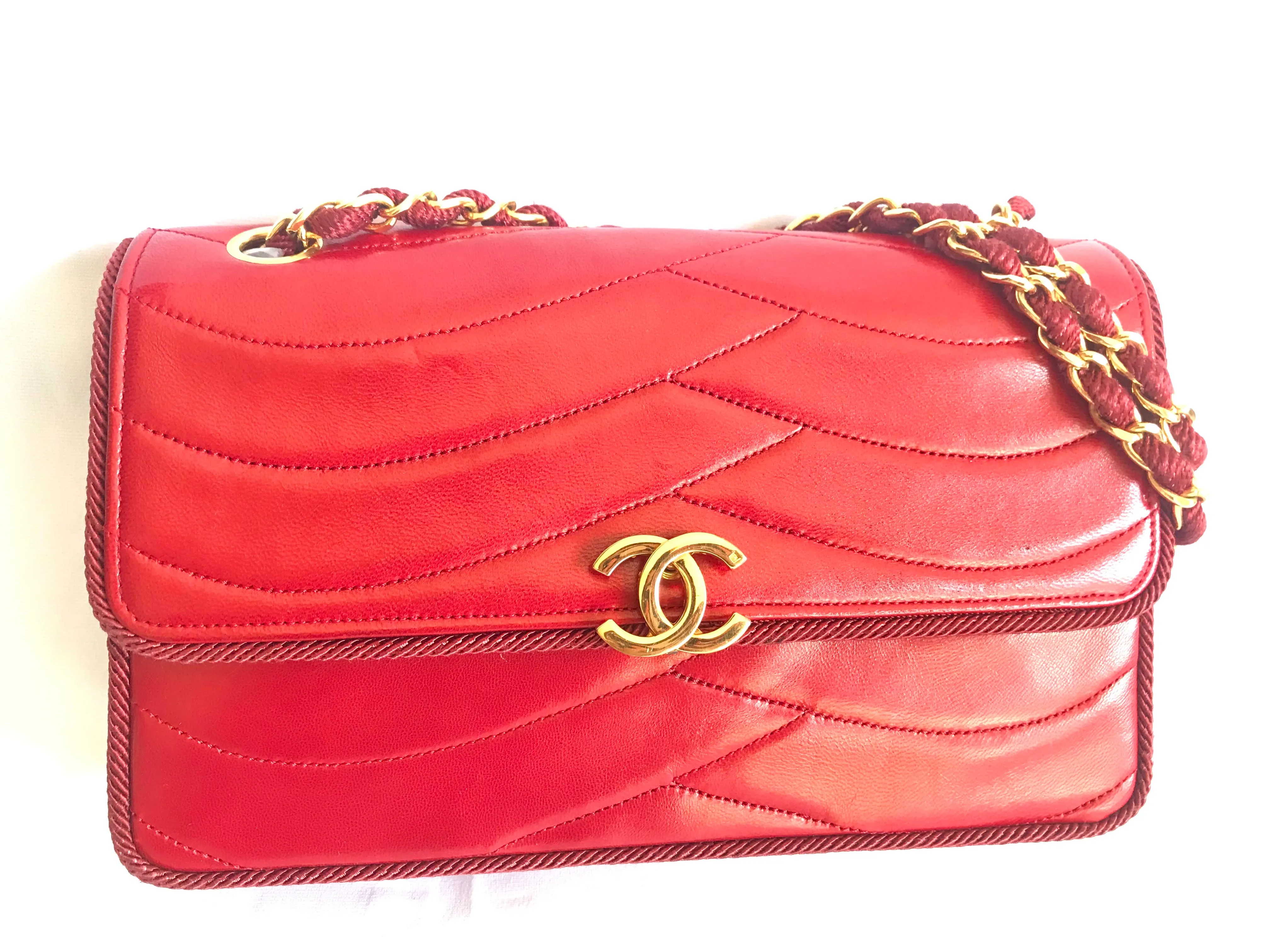 Vintage Chanel red 2.55 shoulder bag with wavy stitches and rope strings and gold chain strap. Very rare piece from the era. 050316r4