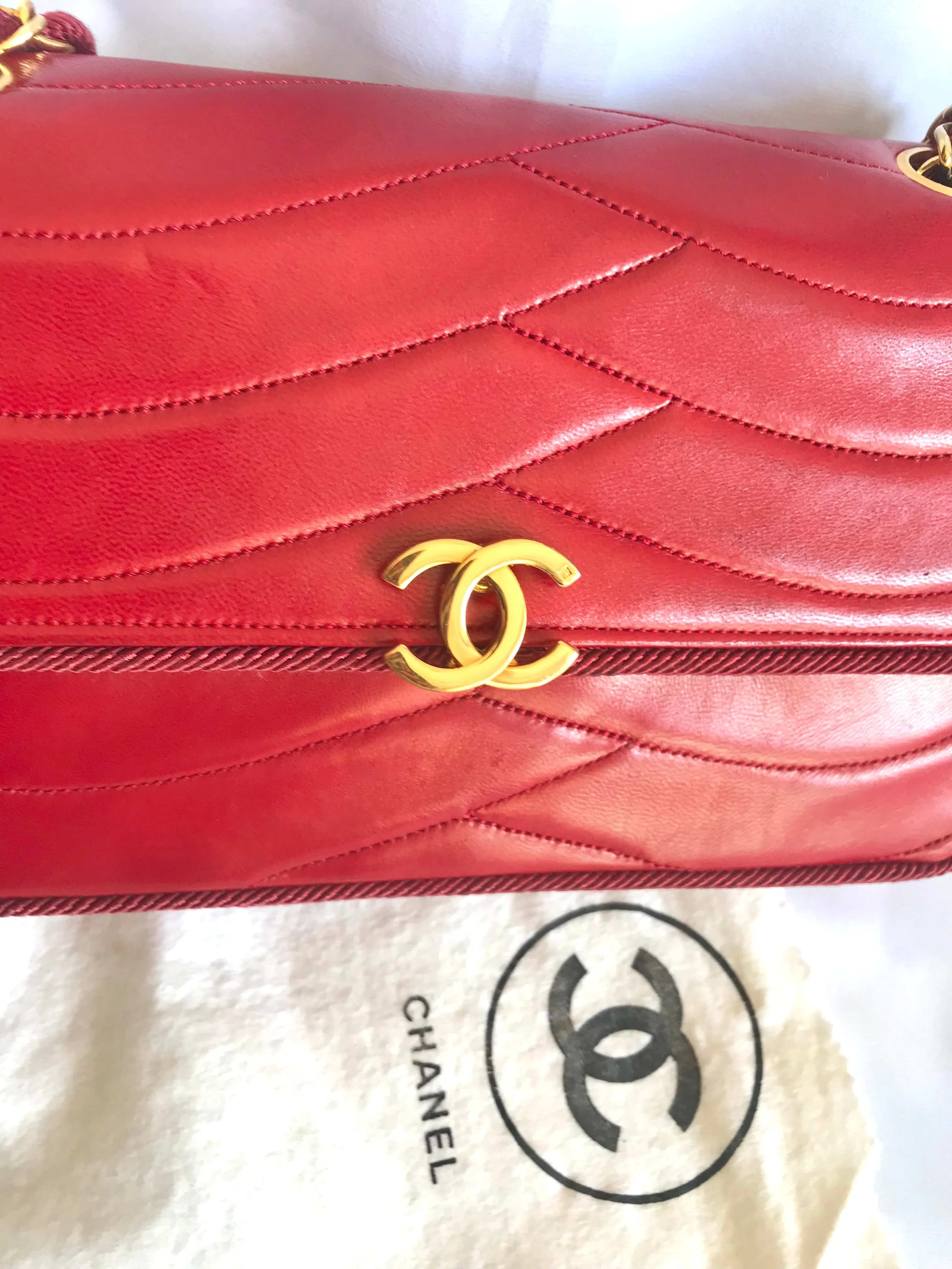 Vintage Chanel red 2.55 shoulder bag with wavy stitches and rope strings and gold chain strap. Very rare piece from the era. 050316r4